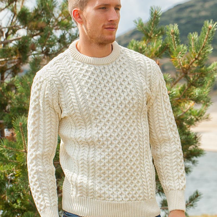Irish Aran Knit Sweater – Timeless Craftsmanship and Comfort

Discover the perfect blend of tradition and style with our unisex Irish Aran Knit Sweater, crafted in Ireland using 100% super-soft Merino wool. 🌿

Luxurious Comfort: Soft, durable, and naturally breathable for year-round wear.
Rich Heritage: Features iconic Aran stitches like cable, honeycomb, and diamond, symbolizing strength, luck, and connection.
Crafted in Ireland: Made with care by skilled artisans, celebrating Irish knitting traditions.
