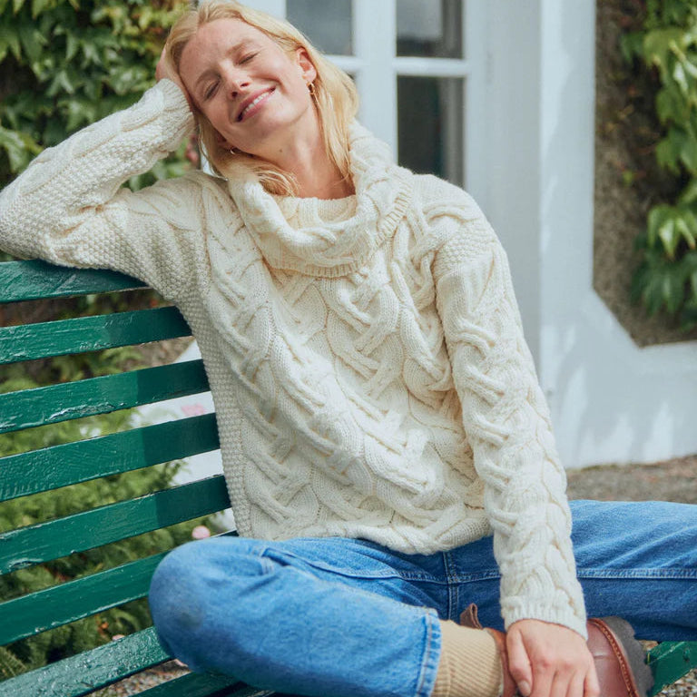 The Kinsale, 100% Aran Knit Sweater – Timeless Irish Style ☘️

Experience year-round warmth and elegance with the Kinsale Aran Knit Sweater, crafted from super-soft Merino wool by Aran Crafts.

✨ Features:

Iconic Cable Stitch: Bold Aran cable stitching takes center stage, complemented by subtle moss stitch side panels.
Elegant Cowl Neck: Adds a cozy and stylish touch.
Heritage Design: Inspired by the rich history of Aran knitwear, made famous globally in the 1950s.
