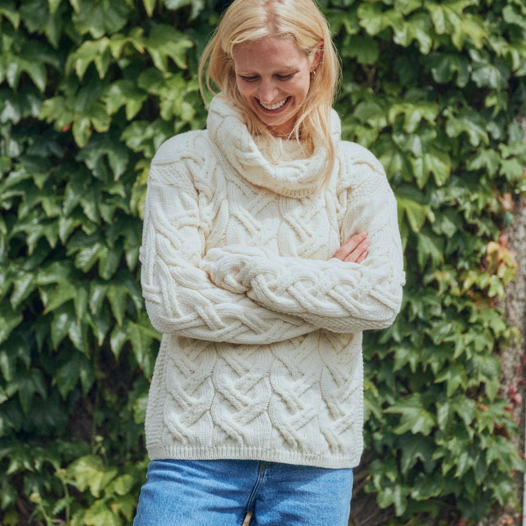 The Kinsale, 100% Aran Knit Sweater – Timeless Irish Style ☘️

Experience year-round warmth and elegance with the Kinsale Aran Knit Sweater, crafted from super-soft Merino wool by Aran Crafts.

✨ Features:

Iconic Cable Stitch: Bold Aran cable stitching takes center stage, complemented by subtle moss stitch side panels.
Elegant Cowl Neck: Adds a cozy and stylish touch.
Heritage Design: Inspired by the rich history of Aran knitwear, made famous globally in the 1950s.