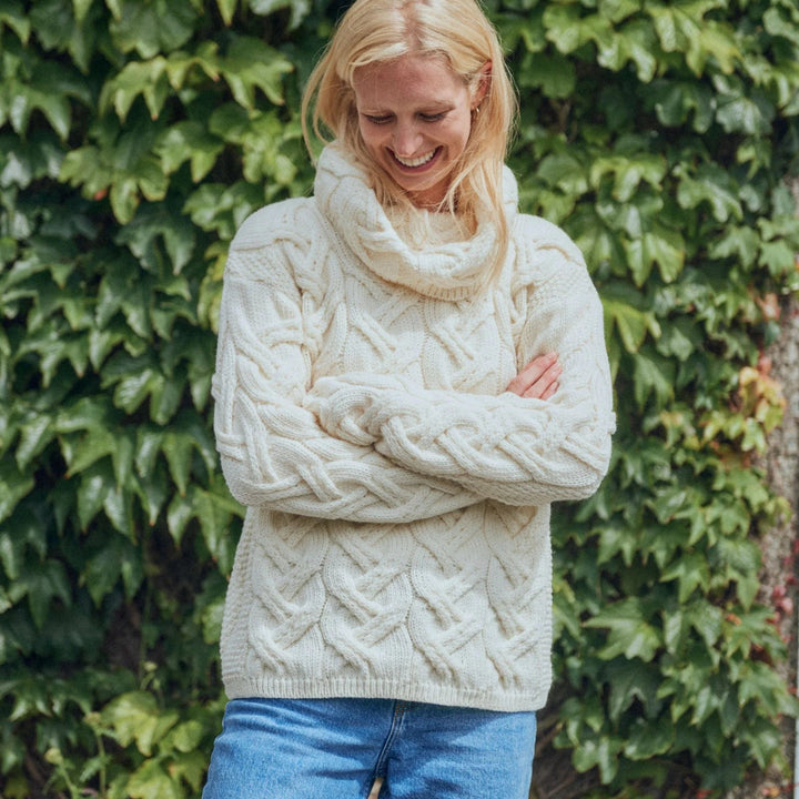 The Kinsale, 100% Aran Knit Sweater – Timeless Irish Style ☘️

Experience year-round warmth and elegance with the Kinsale Aran Knit Sweater, crafted from super-soft Merino wool by Aran Crafts.

✨ Features:

Iconic Cable Stitch: Bold Aran cable stitching takes center stage, complemented by subtle moss stitch side panels.
Elegant Cowl Neck: Adds a cozy and stylish touch.
Heritage Design: Inspired by the rich history of Aran knitwear, made famous globally in the 1950s.