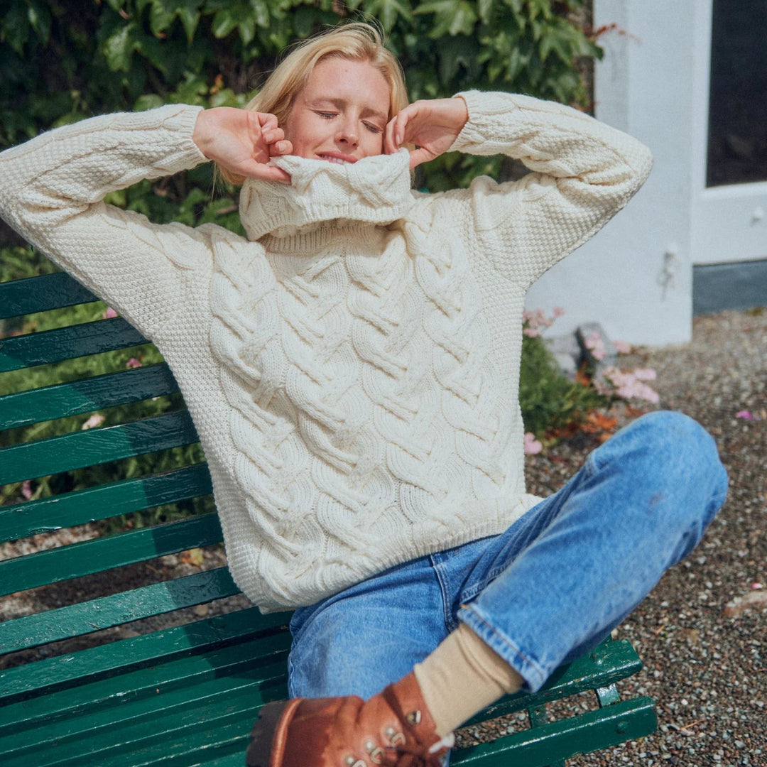 The Kinsale, 100% Aran Knit Sweater – Timeless Irish Style ☘️

Experience year-round warmth and elegance with the Kinsale Aran Knit Sweater, crafted from super-soft Merino wool by Aran Crafts.

✨ Features:

Iconic Cable Stitch: Bold Aran cable stitching takes center stage, complemented by subtle moss stitch side panels.
Elegant Cowl Neck: Adds a cozy and stylish touch.
Heritage Design: Inspired by the rich history of Aran knitwear, made famous globally in the 1950s.