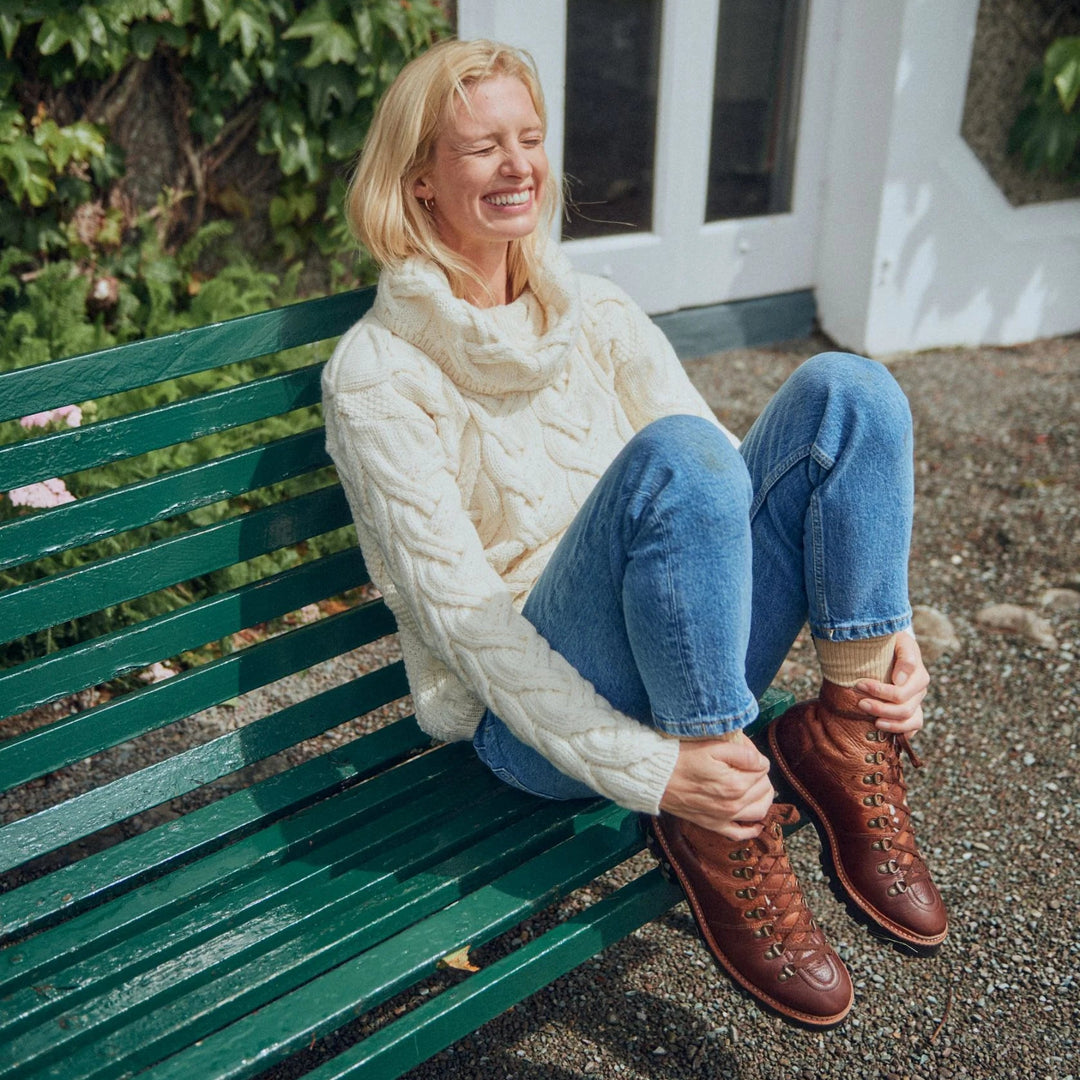 The Kinsale, 100% Aran Knit Sweater – Timeless Irish Style ☘️

Experience year-round warmth and elegance with the Kinsale Aran Knit Sweater, crafted from super-soft Merino wool by Aran Crafts.

✨ Features:

Iconic Cable Stitch: Bold Aran cable stitching takes center stage, complemented by subtle moss stitch side panels.
Elegant Cowl Neck: Adds a cozy and stylish touch.
Heritage Design: Inspired by the rich history of Aran knitwear, made famous globally in the 1950s.