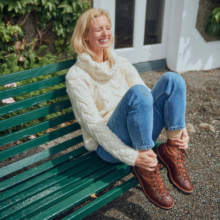 The Kinsale, 100% Aran Knit Sweater – Timeless Irish Style ☘️

Experience year-round warmth and elegance with the Kinsale Aran Knit Sweater, crafted from super-soft Merino wool by Aran Crafts.

✨ Features:

Iconic Cable Stitch: Bold Aran cable stitching takes center stage, complemented by subtle moss stitch side panels.
Elegant Cowl Neck: Adds a cozy and stylish touch.
Heritage Design: Inspired by the rich history of Aran knitwear, made famous globally in the 1950s.