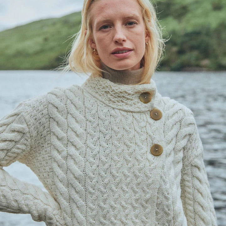 ☘️ Ladies Irish-Made Cable Knit Aran Cardigan 🧶
Comfort, Versatility, and Timeless Elegance

Wrap yourself in the warmth of tradition with our Ladies Irish-Made Cable Knit Aran Cardigan, a perfect fusion of heritage and modern style.

🌟 Key Features You’ll Love:
🧵 Premium Material: Crafted from 100% Supersoft Merino Wool, ensuring exceptional softness and warmth.
✨ Elegant Design: Features a stunning overlapping central trellis panel, combining classic Aran texture with a contemporary twist.