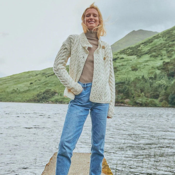 ☘️ Ladies Irish-Made Cable Knit Aran Cardigan 🧶
Comfort, Versatility, and Timeless Elegance

Wrap yourself in the warmth of tradition with our Ladies Irish-Made Cable Knit Aran Cardigan, a perfect fusion of heritage and modern style.

🌟 Key Features You’ll Love:
🧵 Premium Material: Crafted from 100% Supersoft Merino Wool, ensuring exceptional softness and warmth.
✨ Elegant Design: Features a stunning overlapping central trellis panel, combining classic Aran texture with a contemporary twist.