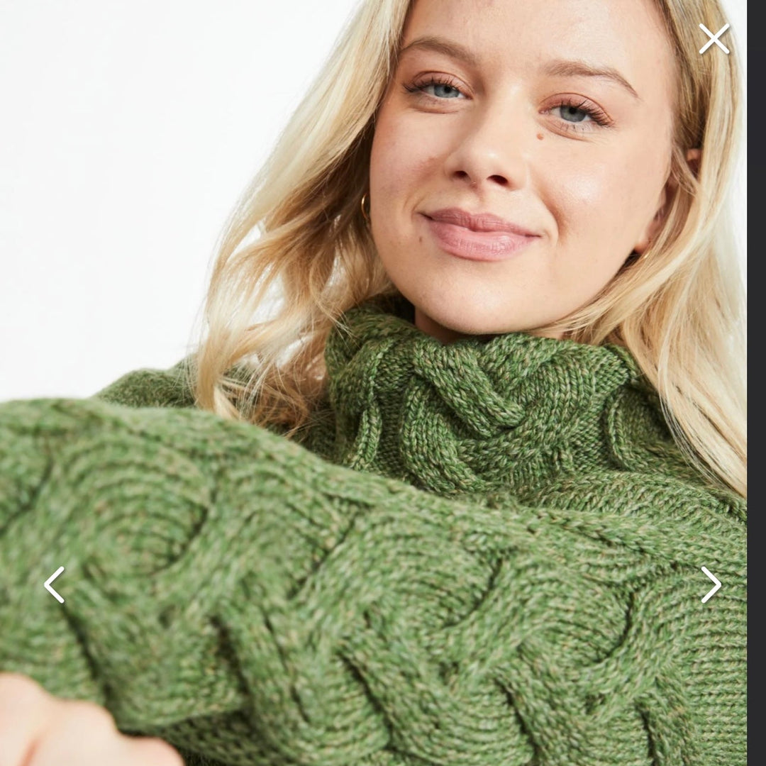 Kinsale 100% Aran Knit Sweater – Timeless Irish Style ☘️

Experience year-round warmth and elegance with the Kinsale Aran Knit Sweater, crafted from super-soft Merino wool by Aran Crafts.

✨ Features:

Iconic Cable Stitch: Bold Aran cable stitching takes center stage, complemented by subtle moss stitch side panels.
Elegant Cowl Neck: Adds a cozy and stylish touch.
Heritage Design: Inspired by the rich history of Aran knitwear, made famous globally in the 1950s.
