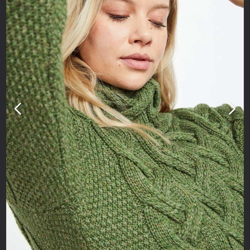 Kinsale 100% Aran Knit Sweater – Timeless Irish Style ☘️

Experience year-round warmth and elegance with the Kinsale Aran Knit Sweater, crafted from super-soft Merino wool by Aran Crafts.

✨ Features:

Iconic Cable Stitch: Bold Aran cable stitching takes center stage, complemented by subtle moss stitch side panels.
Elegant Cowl Neck: Adds a cozy and stylish touch.
Heritage Design: Inspired by the rich history of Aran knitwear, made famous globally in the 1950s.