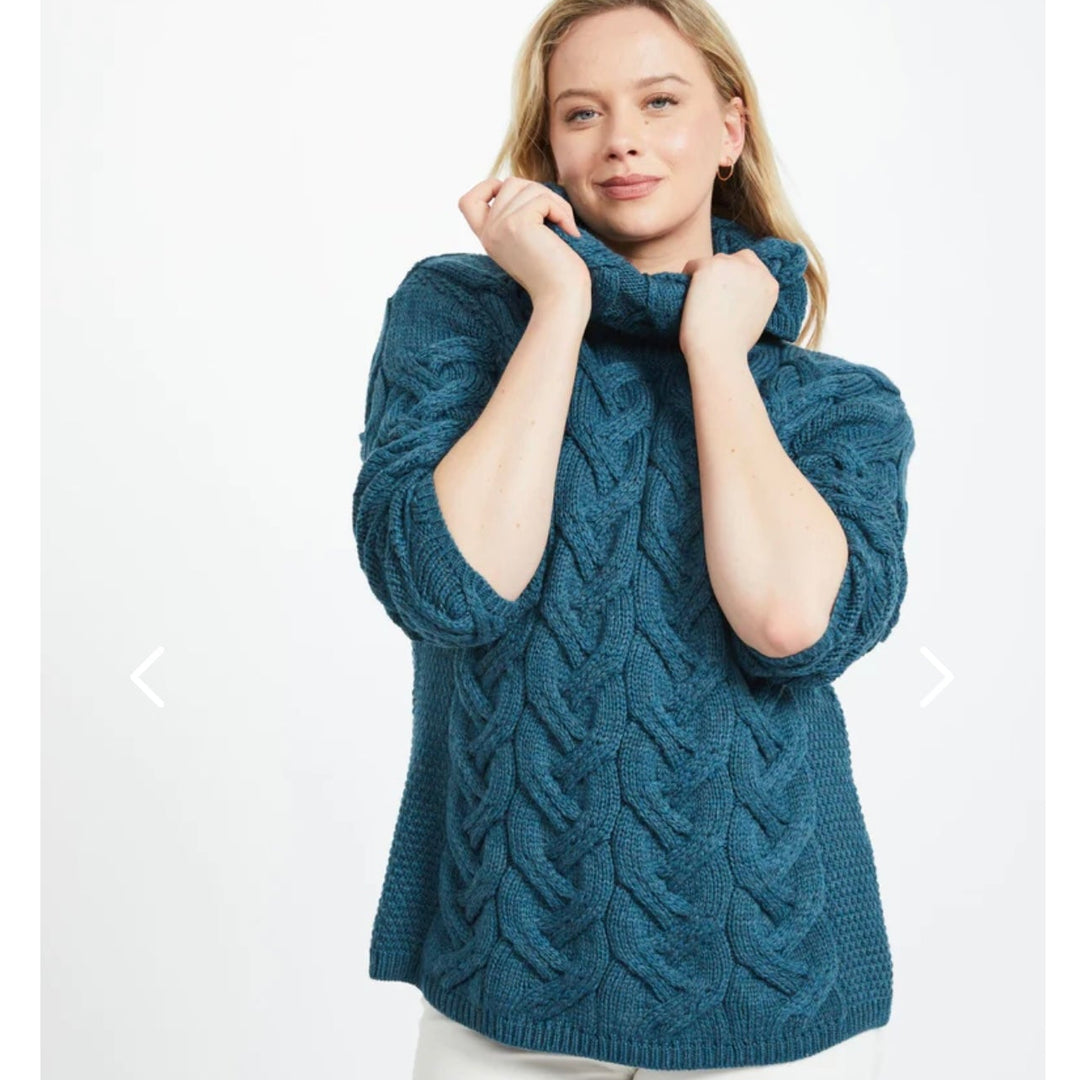 Kinsale 100% Aran Knit Sweater – Timeless Irish Style ☘️

Experience year-round warmth and elegance with the Kinsale Aran Knit Sweater, crafted from super-soft Merino wool by Aran Crafts.

✨ Features:

Iconic Cable Stitch: Bold Aran cable stitching takes center stage, complemented by subtle moss stitch side panels.
Elegant Cowl Neck: Adds a cozy and stylish touch.
Heritage Design: Inspired by the rich history of Aran knitwear, made famous globally in the 1950s.