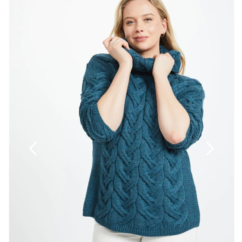 Kinsale 100% Aran Knit Sweater – Timeless Irish Style ☘️

Experience year-round warmth and elegance with the Kinsale Aran Knit Sweater, crafted from super-soft Merino wool by Aran Crafts.

✨ Features:

Iconic Cable Stitch: Bold Aran cable stitching takes center stage, complemented by subtle moss stitch side panels.
Elegant Cowl Neck: Adds a cozy and stylish touch.
Heritage Design: Inspired by the rich history of Aran knitwear, made famous globally in the 1950s.