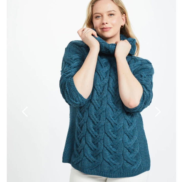 Kinsale 100% Aran Knit Sweater – Timeless Irish Style ☘️

Experience year-round warmth and elegance with the Kinsale Aran Knit Sweater, crafted from super-soft Merino wool by Aran Crafts.

✨ Features:

Iconic Cable Stitch: Bold Aran cable stitching takes center stage, complemented by subtle moss stitch side panels.
Elegant Cowl Neck: Adds a cozy and stylish touch.
Heritage Design: Inspired by the rich history of Aran knitwear, made famous globally in the 1950s.