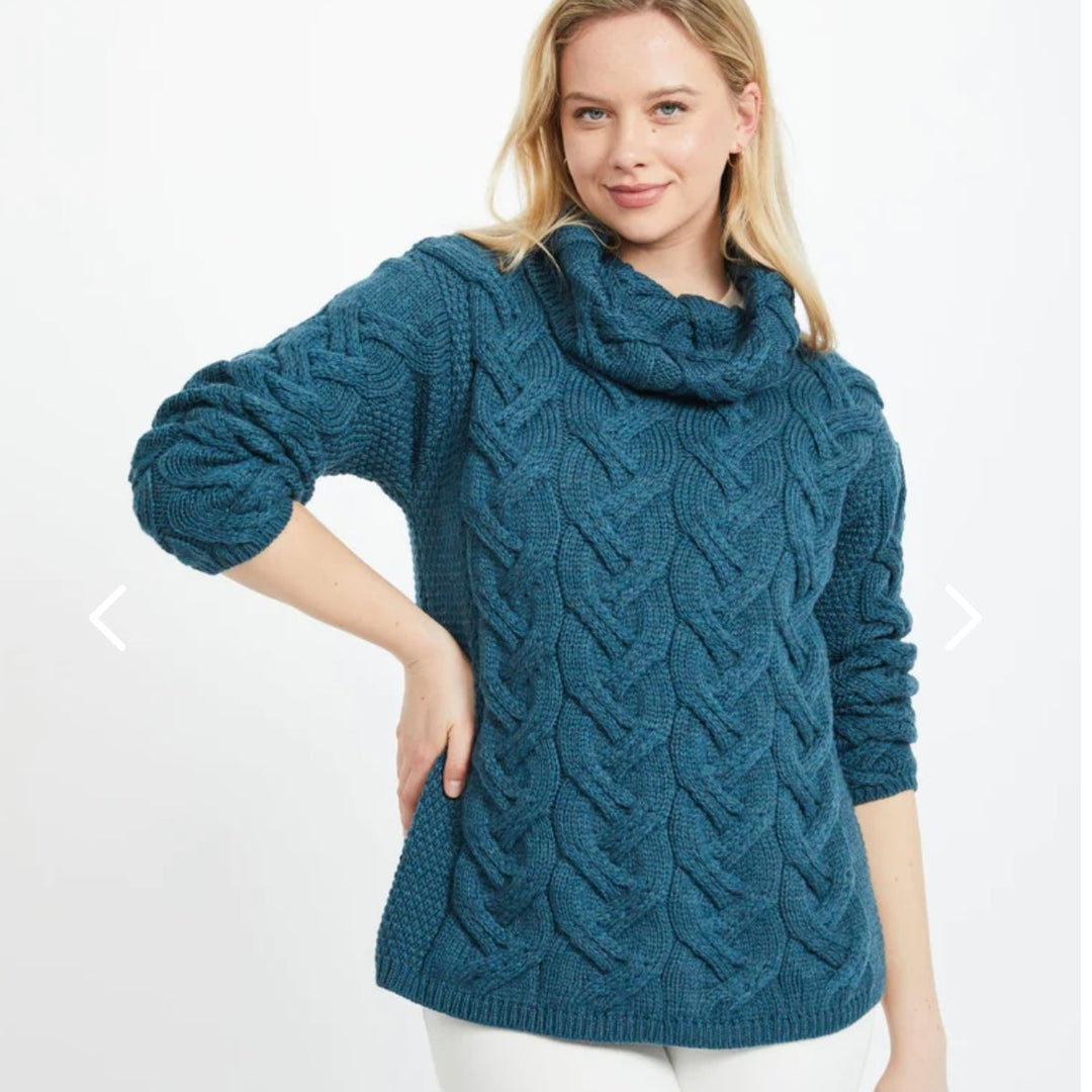 Kinsale 100% Aran Knit Sweater – Timeless Irish Style ☘️

Experience year-round warmth and elegance with the Kinsale Aran Knit Sweater, crafted from super-soft Merino wool by Aran Crafts.

✨ Features:

Iconic Cable Stitch: Bold Aran cable stitching takes center stage, complemented by subtle moss stitch side panels.
Elegant Cowl Neck: Adds a cozy and stylish touch.
Heritage Design: Inspired by the rich history of Aran knitwear, made famous globally in the 1950s.
