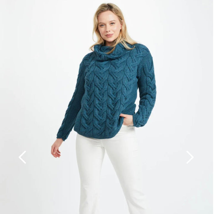 Kinsale 100% Aran Knit Sweater – Timeless Irish Style ☘️

Experience year-round warmth and elegance with the Kinsale Aran Knit Sweater, crafted from super-soft Merino wool by Aran Crafts.

✨ Features:

Iconic Cable Stitch: Bold Aran cable stitching takes center stage, complemented by subtle moss stitch side panels.
Elegant Cowl Neck: Adds a cozy and stylish touch.
Heritage Design: Inspired by the rich history of Aran knitwear, made famous globally in the 1950s.