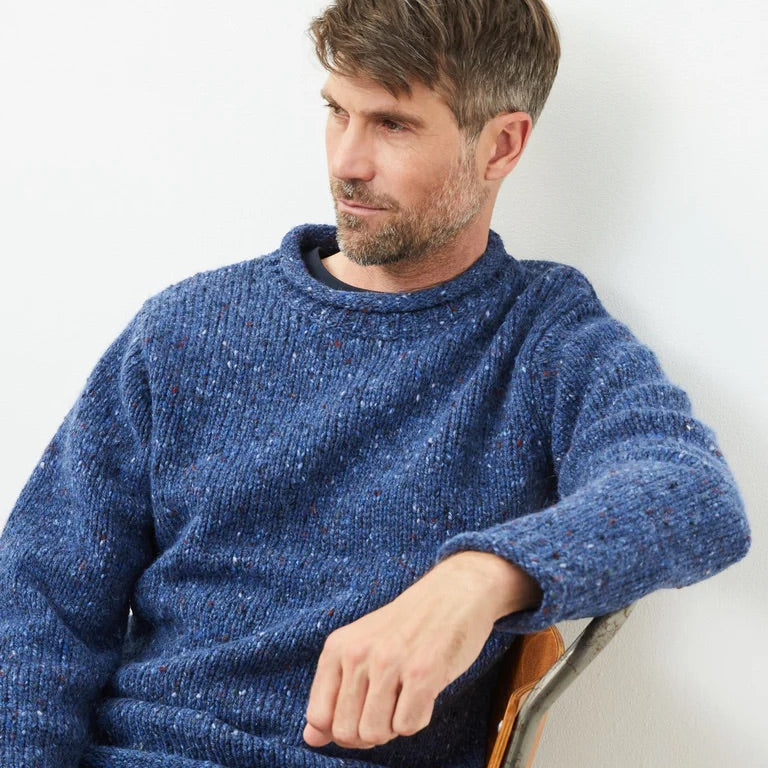 Experience the perfect mix of tradition and modern design with the Raheen Tweed Roll Neck Sweater, crafted from 100% Pure New Wool.

✨ Key Features:

Material: Luxurious 100% Pure New Wool for warmth and comfort. 🐑
Design: Rolled crew neck with ribbed hem and cuffs for a relaxed yet flattering fit. 🎨
Details: Set-in sleeves and fully linked seams ensure a smooth, seamless finish. 🧵
Versatility: Perfect for layering or wearing solo, ideal for smart-casual or cozy weekends.