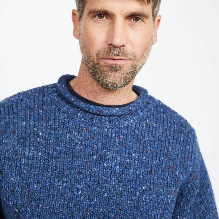 Experience the perfect mix of tradition and modern design with the Raheen Tweed Roll Neck Sweater, crafted from 100% Pure New Wool.

✨ Key Features:

Material: Luxurious 100% Pure New Wool for warmth and comfort. 🐑
Design: Rolled crew neck with ribbed hem and cuffs for a relaxed yet flattering fit. 🎨
Details: Set-in sleeves and fully linked seams ensure a smooth, seamless finish. 🧵
Versatility: Perfect for layering or wearing solo, ideal for smart-casual or cozy weekends.