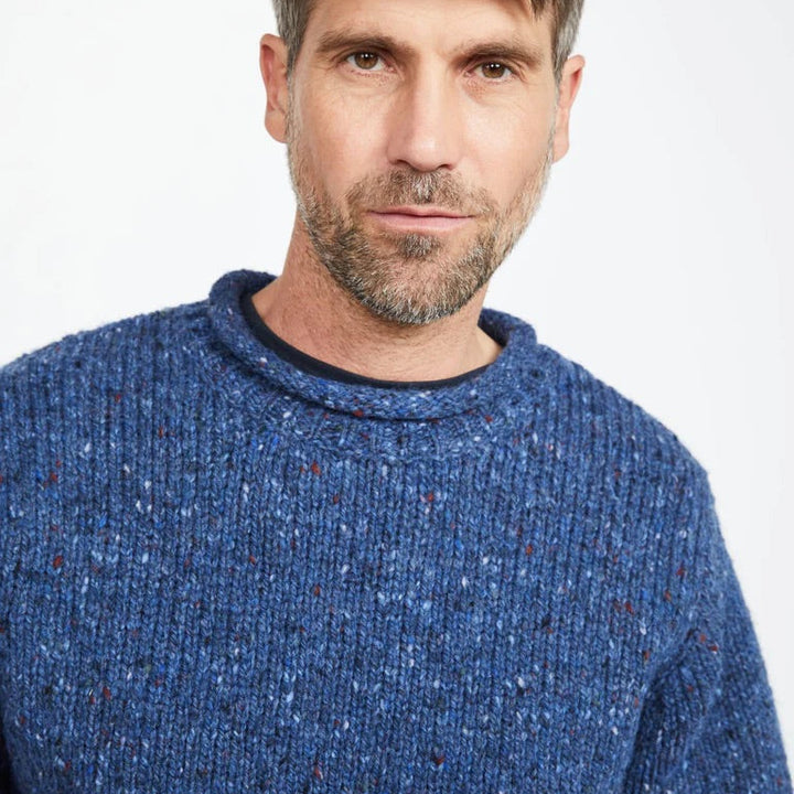 Experience the perfect mix of tradition and modern design with the Raheen Tweed Roll Neck Sweater, crafted from 100% Pure New Wool.

✨ Key Features:

Material: Luxurious 100% Pure New Wool for warmth and comfort. 🐑
Design: Rolled crew neck with ribbed hem and cuffs for a relaxed yet flattering fit. 🎨
Details: Set-in sleeves and fully linked seams ensure a smooth, seamless finish. 🧵
Versatility: Perfect for layering or wearing solo, ideal for smart-casual or cozy weekends.