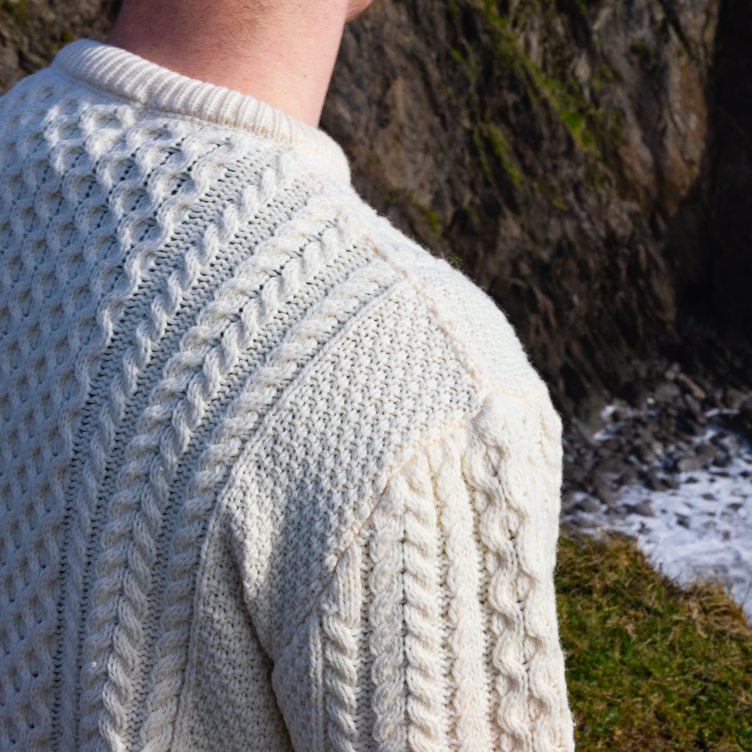Irish Aran Knit Sweater – Timeless Craftsmanship and Comfort

Discover the perfect blend of tradition and style with our unisex Irish Aran Knit Sweater, crafted in Ireland using 100% super-soft Merino wool. 🌿

Luxurious Comfort: Soft, durable, and naturally breathable for year-round wear.
Rich Heritage: Features iconic Aran stitches like cable, honeycomb, and diamond, symbolizing strength, luck, and connection.
Crafted in Ireland: Made with care by skilled artisans, celebrating Irish knitting traditions.
