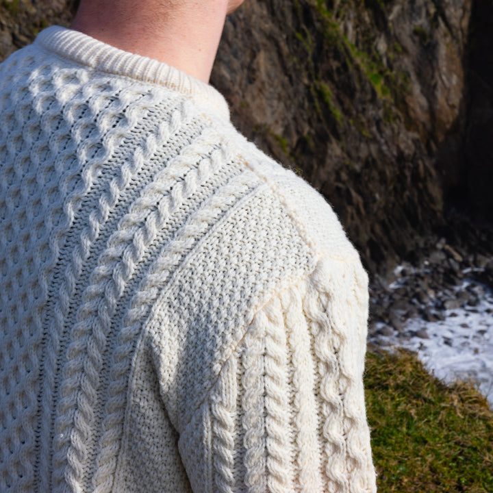 Irish Aran Knit Sweater – Timeless Craftsmanship and Comfort

Discover the perfect blend of tradition and style with our unisex Irish Aran Knit Sweater, crafted in Ireland using 100% super-soft Merino wool. 🌿

Luxurious Comfort: Soft, durable, and naturally breathable for year-round wear.
Rich Heritage: Features iconic Aran stitches like cable, honeycomb, and diamond, symbolizing strength, luck, and connection.
Crafted in Ireland: Made with care by skilled artisans, celebrating Irish knitting traditions.
