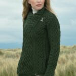☘️ Ladies Irish-Made Side-Zip Cable Knit Aran Cardigan 🧶
Biker Style Meets Timeless Irish Craftsmanship

Elevate your wardrobe with the Ladies Irish-Made Side-Zip Cable Knit Aran Cardigan, a bold take on traditional Aran knitwear with a modern, biker-inspired twist.

🌟 Key Features You’ll Love:
🧵 Premium Material: Made from 100% Supersoft Merino Wool for unmatched warmth, softness, and comfort.
🪡 Stylish Design: Features a unique side-zip closure, adding a modern biker edge to the classic Aran car