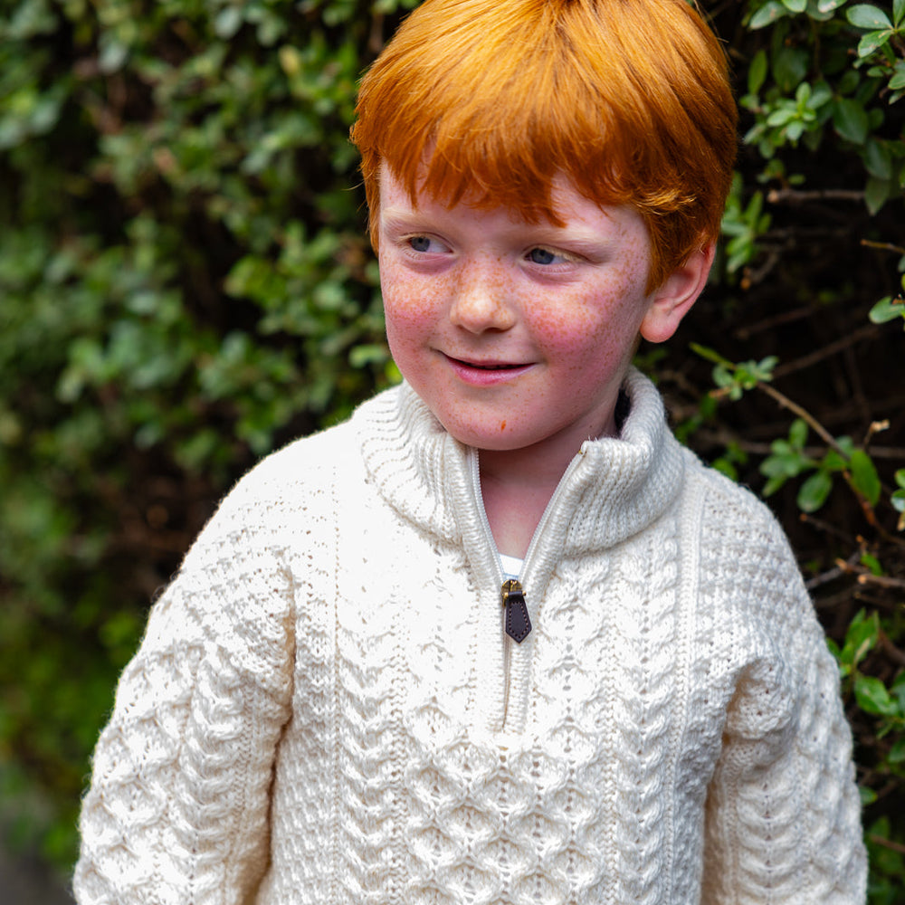 “Authentic Aran sweater in Dingle, Ireland”
Children's Authentic Aran Knitwear – Irish Craftsmanship & Timeless Style

Wrap your little ones in the enchanting warmth of authentic Aran knit cardigans and sweaters, crafted in Ireland with 100% soft merino wool for unbeatable comfort and durability.

🌟 Heritage Design: Featuring intricate Aran stitches like cable, honeycomb, and trinity, each piece tells a unique story.