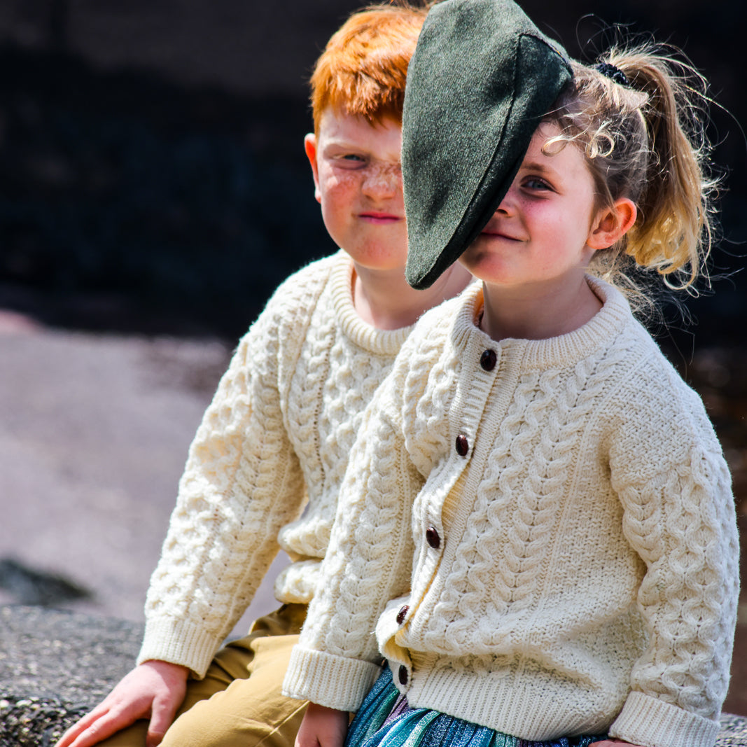Children's Authentic Aran Knitwear – Irish Craftsmanship &amp; Timeless Style

Wrap your little ones in the enchanting warmth of authentic Aran knit cardigans and sweaters, crafted in Ireland with 100% soft merino wool for unbeatable comfort and durability.

🌟 Heritage Design: Featuring intricate Aran stitches like cable, honeycomb, and trinity, each piece tells a unique story.
🍂 Versatile Styles: From cozy crew necks to classic button-downs, perfect for layering or keeping warm.