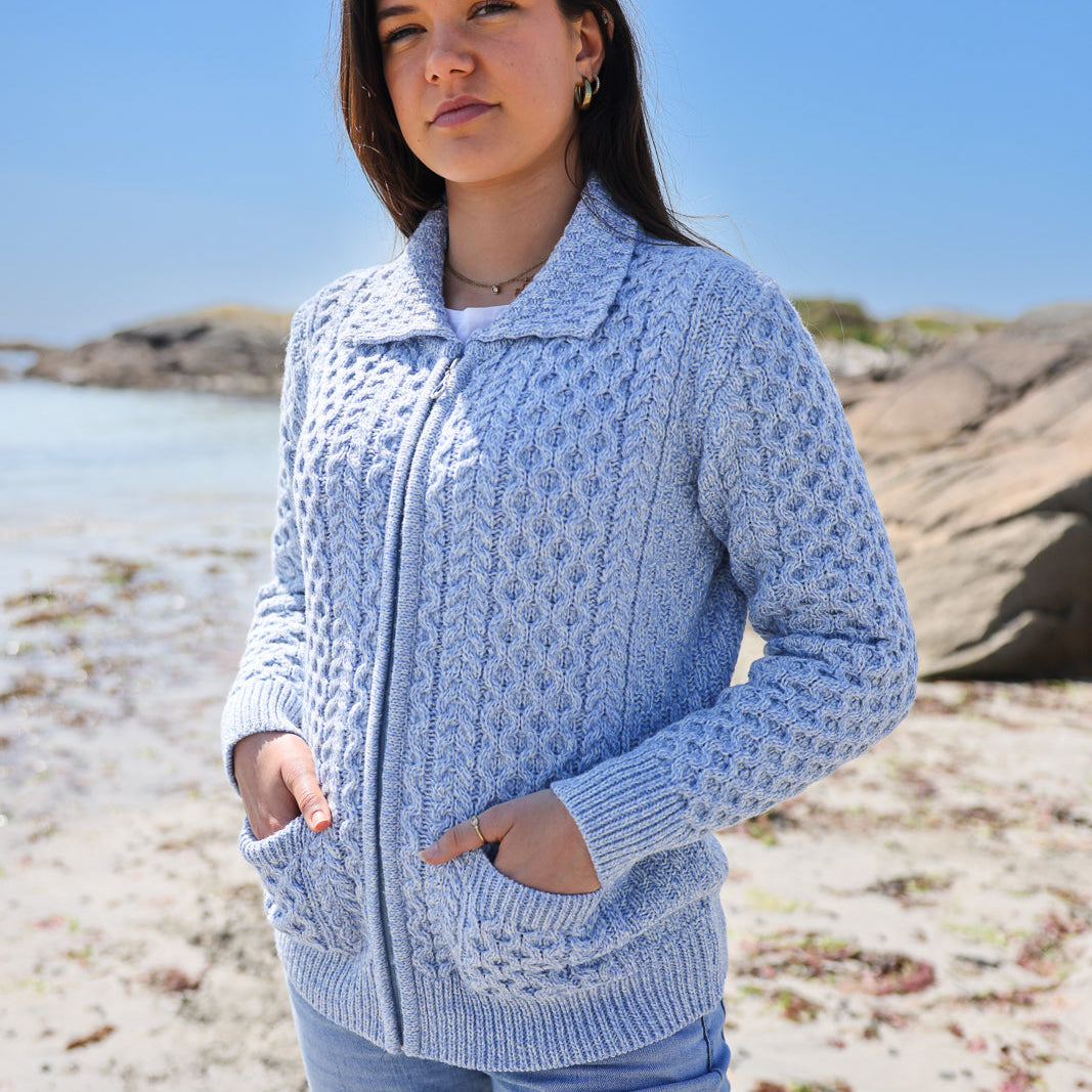 Ladies' Aran Wool Cardigan – Timeless Irish Style 🌿🐑

Stay cozy in our Ladies' Aran Wool Cardigan, crafted from 100% super-soft Merino wool. 🧶 Featuring intricate Aran stitches like cable, diamond, and honeycomb, this open-front design blends Irish heritage with modern elegance.

Perfect for layering, it keeps you warm in winter and cool in summer, thanks to Merino wool's natural temperature-regulating properties. 🌞❄️ Available in natural hues inspired by Ireland’s rugged beauty, this cardigan is a vers