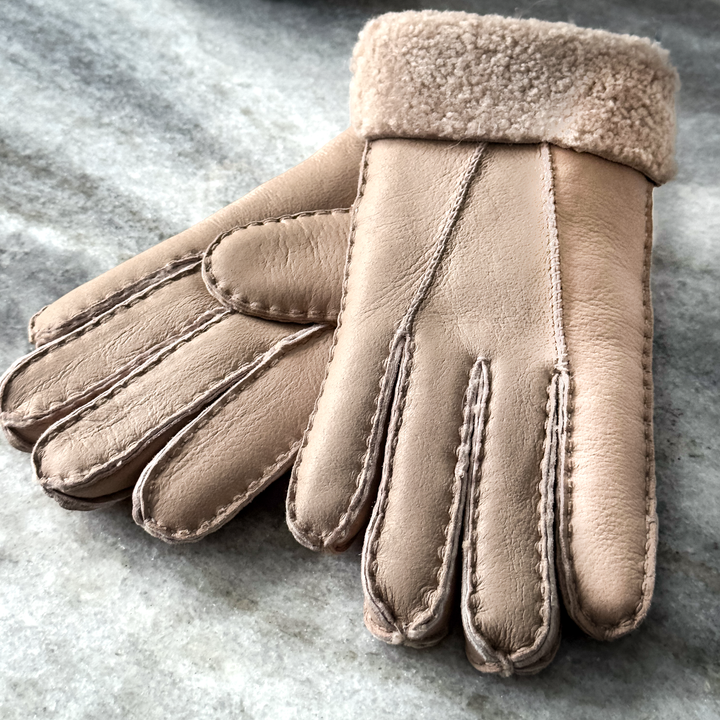 Indulge in unmatched comfort and sophistication with our exquisite sheepskin gloves, meticulously crafted to elevate your winter wardrobe. Made from premium sheepskin leather, these gloves offer unparalleled softness and warmth, ensuring your hands stay cozy even in the coldest of temperatures.