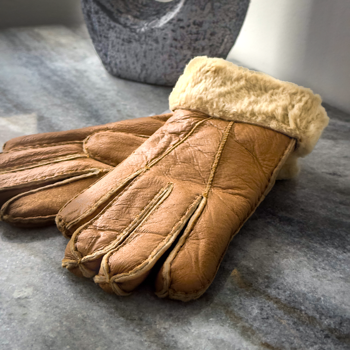 Indulge in unmatched comfort and sophistication with our exquisite sheepskin gloves, meticulously crafted to elevate your winter wardrobe. Made from premium sheepskin leather, these gloves offer unparalleled softness and warmth, ensuring your hands stay cozy even in the coldest of temperatures.